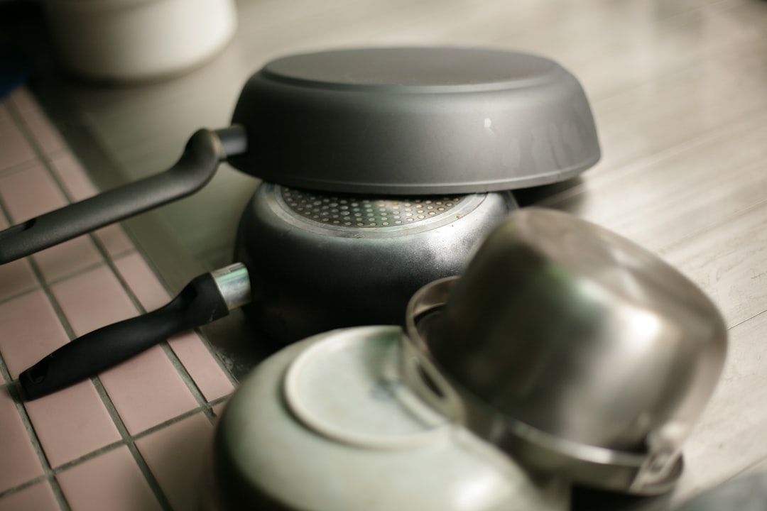two-frying-pans-stacked-on-a-stovetop-veixke3bqt8